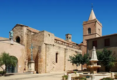 an old stone church with a tower and a steeple at Gîte la Cave in Quarante