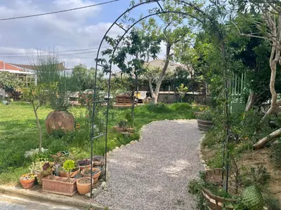 a garden with a arbor and plants in a yard at Les volets verts in Saint-Laurent-de-la-Cabrerisse