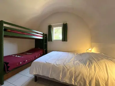 a bedroom with a bed and a bunk bed at Pavillon Bora Bora, 2 salles d eau et piscine - GA090-002 in Gruissan