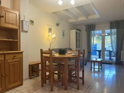 a kitchen and dining room with a table and chairs at Pavillon Bora Bora, 2 salles d eau et piscine - GA090-002 in Gruissan