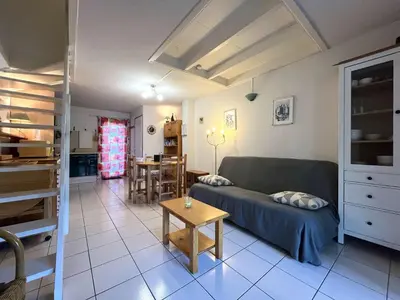 a living room with a couch and a table at Pavillon Bora Bora, 2 salles d eau et piscine - GA090-002 in Gruissan