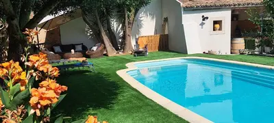 a swimming pool in the yard of a house at Le MAS CLEMENTINE in Puisserguier