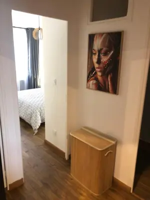 a room with a painting of a woman on the wall at APPARTEMENT F3 BOX Vélo Moto Centre historique in Mirepoix