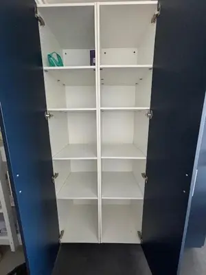 a white cabinet with empty shelves in a room at Studio Cabine Vue Port Gruissan in Gruissan