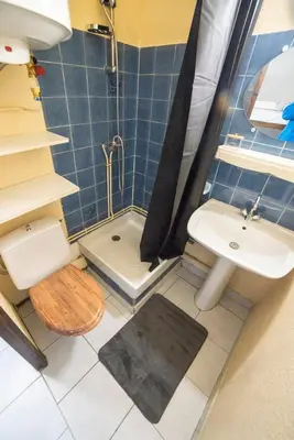 a bathroom with a sink and a toilet and a shower at Vue lac & mer à pied - Séjour détente in Port-la-Nouvelle