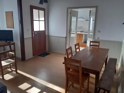 a dining room with a wooden table and chairs at Maison 3 chambres - 25mn de Toulouse in Caraman