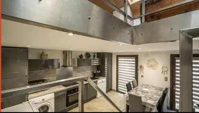 a kitchen with a stove and a table in it at Casa Alegria in Portel-des-Corbières