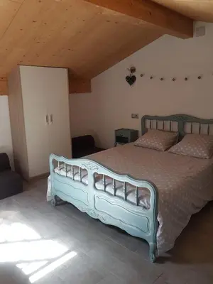 a bedroom with a blue bed in a room at Casa Alegria in Portel-des-Corbières