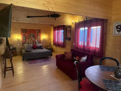 a living room with a bed and a couch at HARRY POTTER-Chalet du Sanglier Magique - in Boutenac