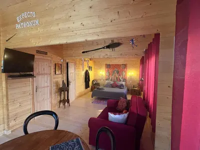 a living room with a couch and a bed at HARRY POTTER-Chalet du Sanglier Magique - in Boutenac