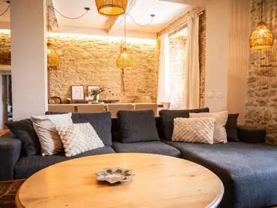 a living room with a couch and a table at Domaine de Vadel in Veilhes