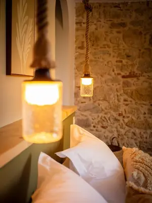 a bedroom with two lights hanging from a wall at Domaine de Vadel in Veilhes