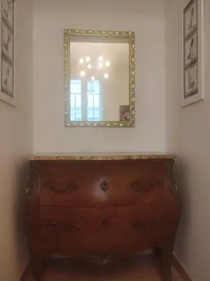 a dresser in a room with a mirror on the wall at Appartement exceptionnel Bastide St Louis in Carcassonne