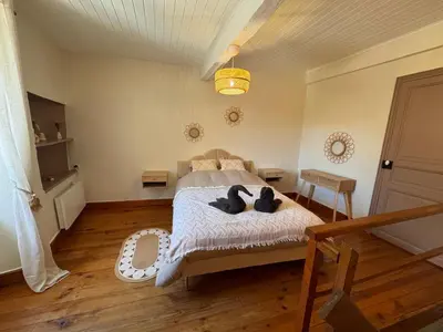 a bedroom with a bed with two black stuffed animals on it at La Bohème - Cosy, calme & confort in Saint-Papoul