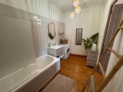 a white bathroom with a tub and a sink at La Bohème - Cosy, calme & confort in Saint-Papoul