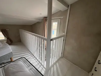 a staircase in a room with a window at La bâtisse de Coustouge in Coustouge