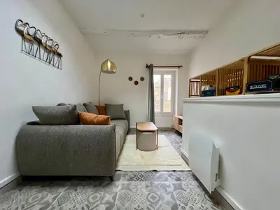 a living room with a couch and a table at La bâtisse de Coustouge in Coustouge