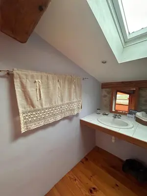 a bathroom with a sink and a towel on the wall at Maison de charme à Bélesta in Bélesta