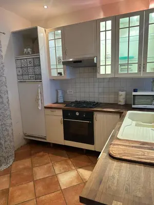 a kitchen with a white refrigerator and a stove at Maison de charme à Bélesta in Bélesta