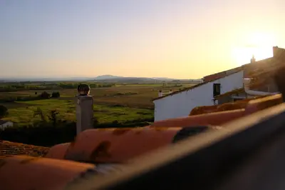 a view from the roof of a house with the sunset at Maison de charme et vue Imprenable à 180 degrés sur les vignes et Pyrénées in Paraza