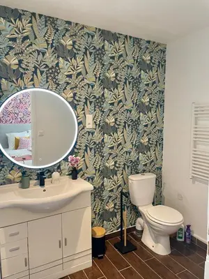a bathroom with a sink and a toilet and a mirror at Stylish Apartment with Balcony - Very Central - Long Stays and Pets Welcome in Carcassonne