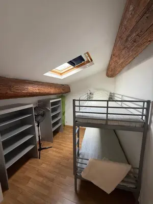a bedroom with two bunk beds and a skylight at Gîte au cœur d un caveau de dégustation de vin in Olonzac