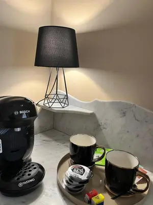 two coffee cups on a tray next to a lamp at Aux 138 in Carcassonne