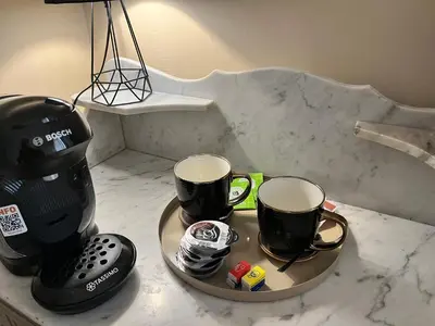 two coffee mugs on a tray on a counter at Aux 138 in Carcassonne