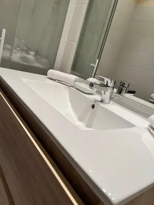 a bathroom with a white sink and a mirror at Aux 138 in Carcassonne