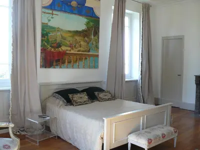 a bedroom with a bed and a painting on the wall at Villa Boulmia in Burlats