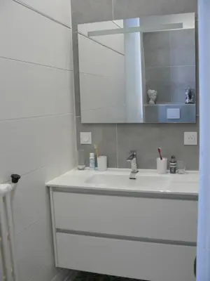 a white bathroom with a sink and a mirror at Villa Boulmia in Burlats