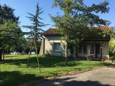 a small house with a tree in front of it at En vayssieres