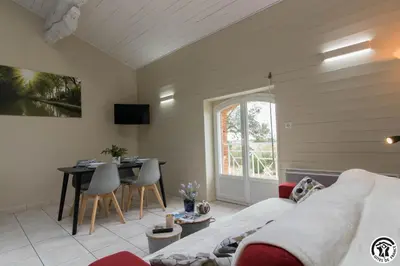 a living room with a couch and a table at Tournesols