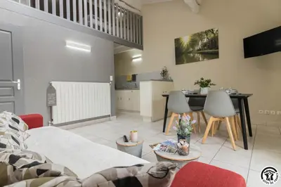 a living room with a couch and a table at Tournesols
