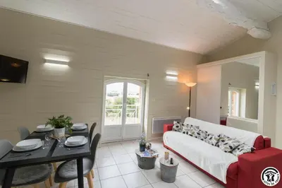 a living room with a couch and a table at Tournesols
