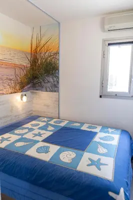 a bedroom with a bed with a view of the beach at Le Nautilus in Gruissan