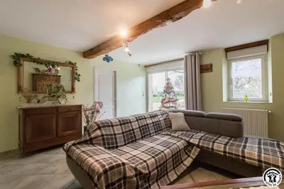 a living room with a couch and a mirror at Perets petit in Montégut-Lauragais