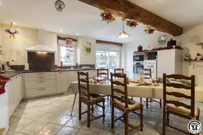 a kitchen with a table and chairs in a room at Perets petit in Montégut-Lauragais