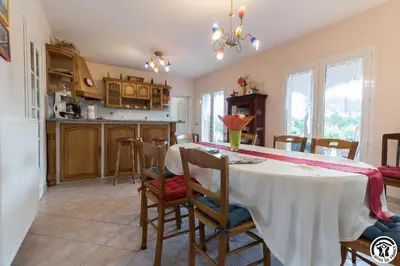 a kitchen and dining room with a table and chairs at Balanquier in Lagarde