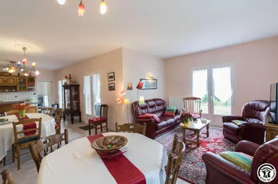 a living room with couches and a dining room at Balanquier in Lagarde