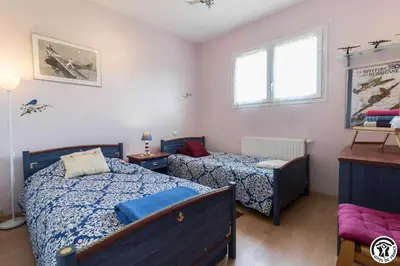 a bedroom with two beds and a window at Balanquier in Lagarde