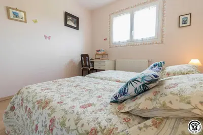 a bedroom with two twin beds and a window at Balanquier in Lagarde