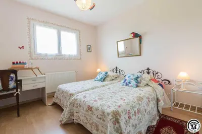a bedroom with a bed and a dresser and a window at Balanquier in Lagarde