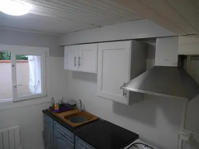 a kitchen with a sink and a stove at Les platanes in Aignes
