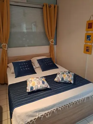 a bed with two pillows on it with a window at Plage du grazel le thalassa in Gruissan