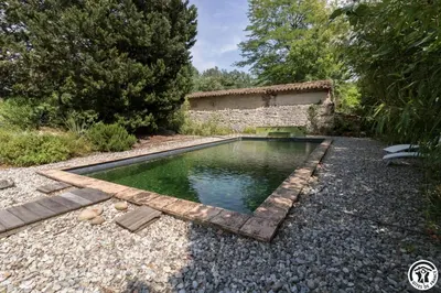 a pool of water in the middle of a garden at Chateau sud in Cessales