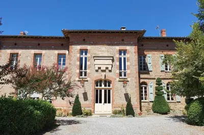 a large brick house with a white door at Chateau sud in Cessales