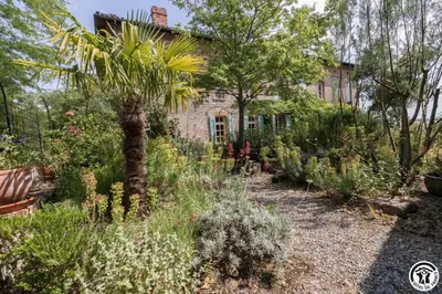 a garden in front of a house with plants at Chateau sud in Cessales