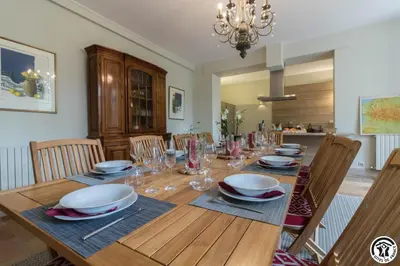 a dining room with a wooden table and chairs at Chateau sud in Cessales