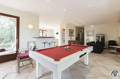 a living room with a pool table in it at La maison imart in Revel